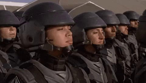 Clip from “Starship Troopers.” A young, armor-clad soldier (Mylin Brooks-Stoddard), standing among ranks of similarly armored soldiers, turns to the camera and proclaims, “I’m doing my part!”
