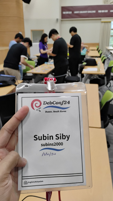 A badge with title "DebConf24", subtitle "Busan, South Korea". It also has the name "Subin Siby" with caption "English, Malayalam"