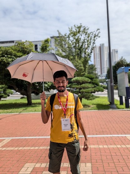 Person holding an umbrella in the sun