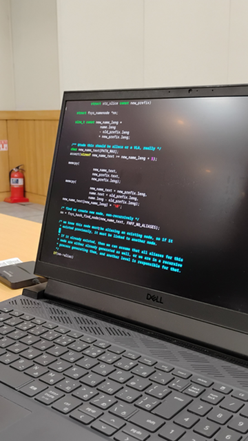 A laptop screen with C code