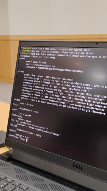 A laptop screen with .gitconfig file