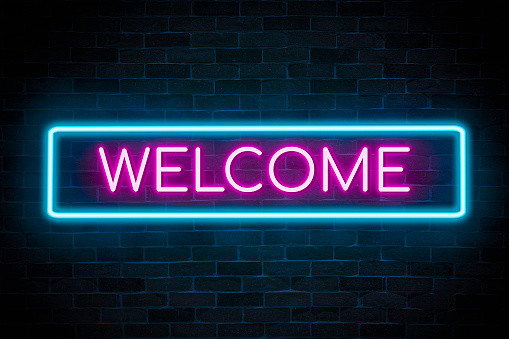 An image that looks like a neon sign that says WELCOME. The border is in a turquoise color and the word welcome is in a pink color.