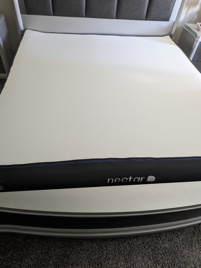 A photo of my new Nectar memory foam mattress that we just took out of the box and out of the plastic and is starting to expand.