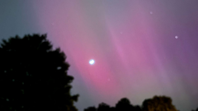 A photo my wife took of the Northern Lights that we saw last night here in Winston Salem, NC.

You can see the moon as well as some pink and purple clouds due to the lights.