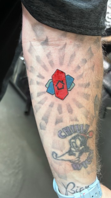 A photo of the Nova Launcher Android app logo that I got tattooed on my left arm today.