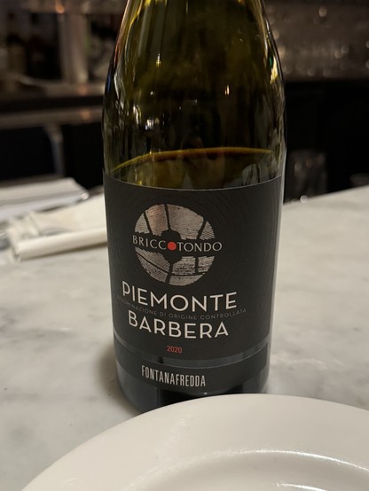 Bottle of wine labeled BRICCOTONDO
PIEMONTE
ANON NATIONE DI ORIGINE CONTROLLATA
BARBERA
2020
FONTANAFREDDA