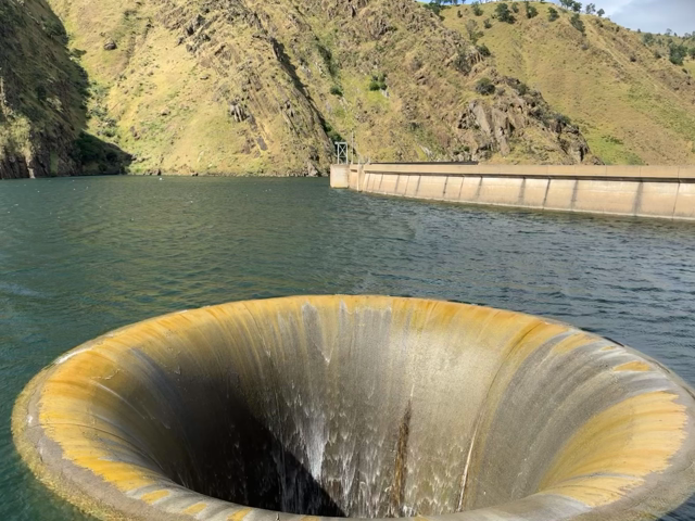 Looping gif of water pouring into “the glory hole” overflow in lake berryessa. 