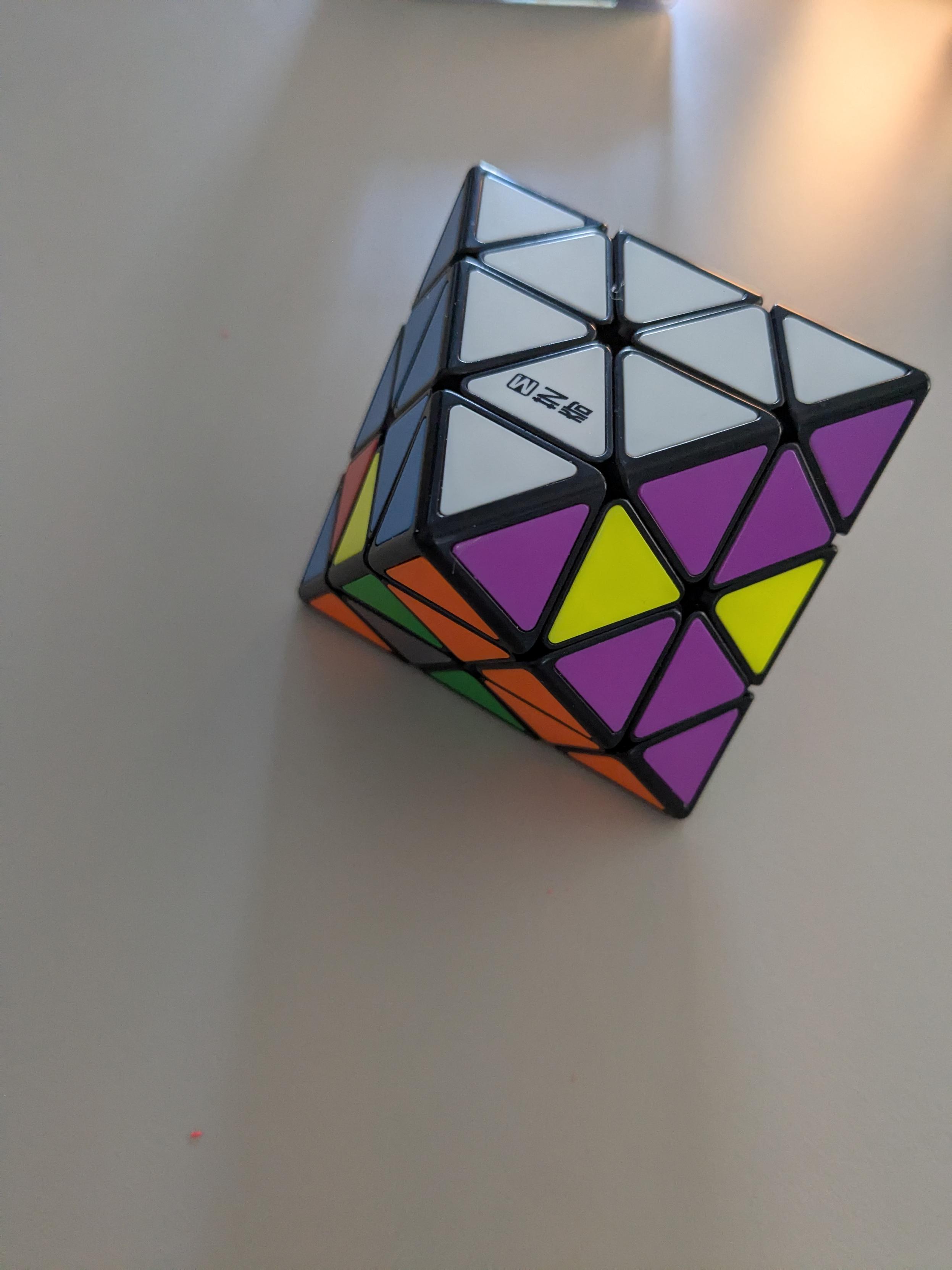 Octagonal Rubik's cube like puzzle, the white face on top of partly solved