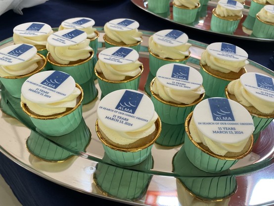 Closeup of the cupcakes and ALMA logos, with the inscription

IN SEARCH OF OUR COSMIC ORIGINS

and

11 YEARS, MARCH 13 2024