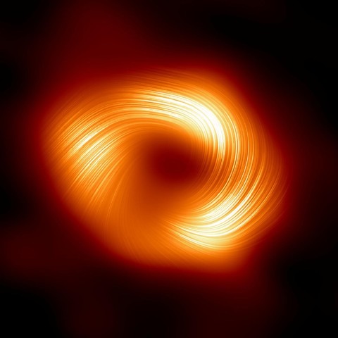 Event Horizon Telescope image of Sag A*, the supermassive black hole at the center of the Milky Way galaxy.

The background is mostly black, but a kind of hairy, slightly squashed donut shape in orange can be seen. The central blackness is the shadow of the Sag A*.

The hairy aspect comes from visualising the strength of the magnetic field.