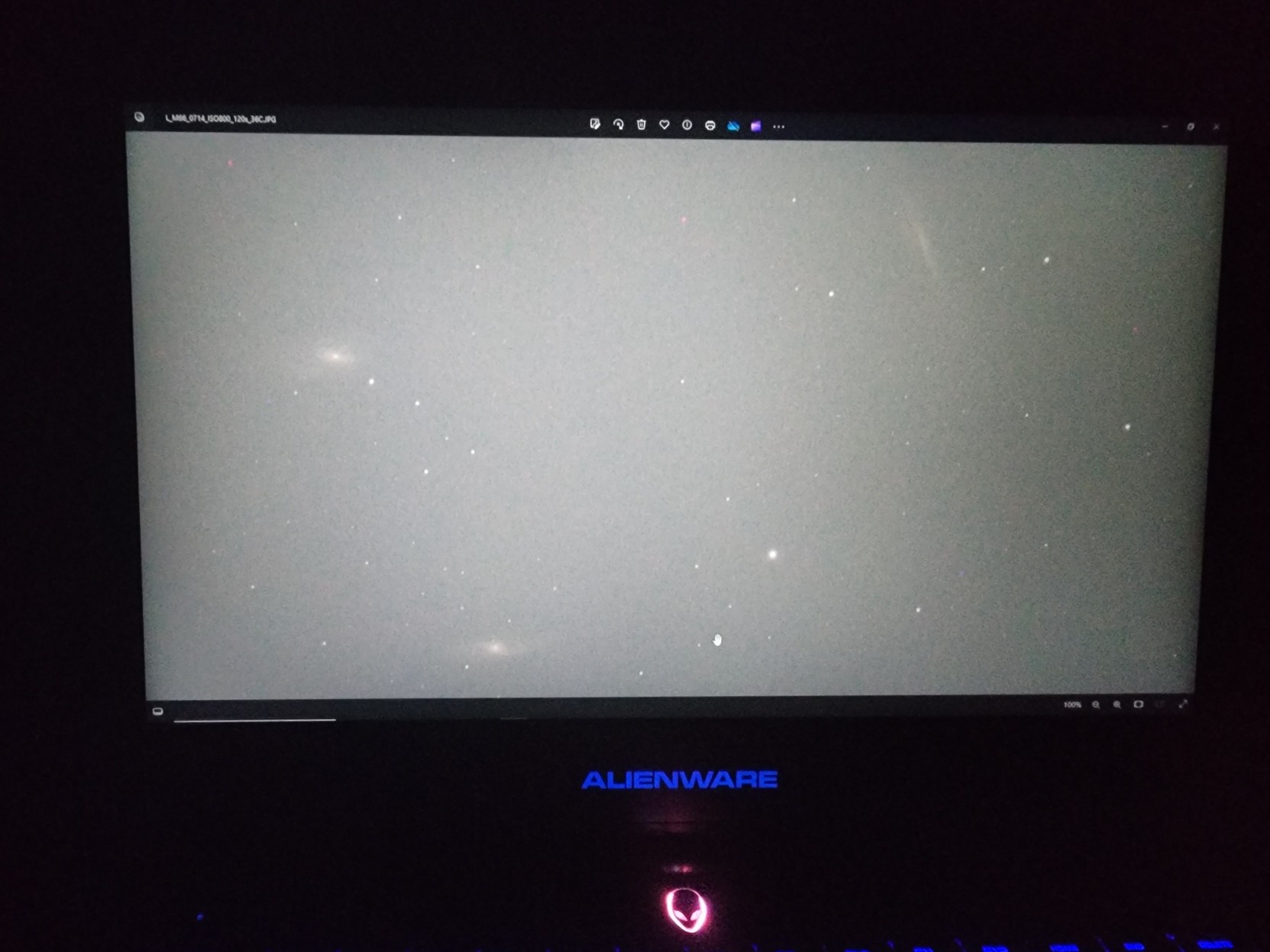 Laptop screen showing 3 galaxies in horrible light pollution.