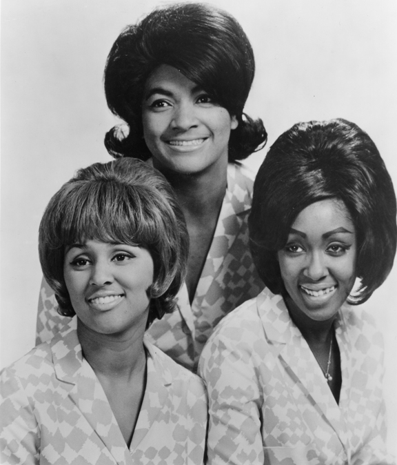 The Blossoms in 1966 (clockwise from top: Fanita James, Jean King, and Darlene Love). They are wearing 60s era hair styles and matching light colored, patterned blazers