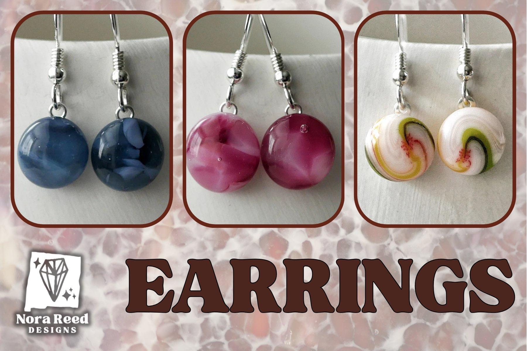 ad for earrings featuring 3 pairs of round dangly earrings in a dark inky purple, a magenta/pink and a white/pink/green/yellow/red swirl