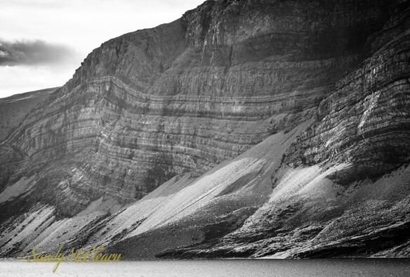 Folded sedimentation layers exposed on the side of a mountain. 