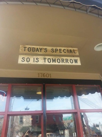 A hanging sign reading 

TODAY'S SPECIAL

in front of a restaurant

Hanging from that sign is another sign in the same font that reads

SO IS TOMORROW