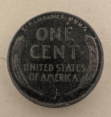 The back side of that penny which does not have the Lincoln Memorial, but instead has the wheat stalks and the words

ONE
CENT
United States
Of America

And the words "e pluribus unum" in small print across the top rim 