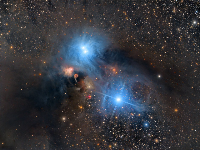 The small Southern constellation of Corona Australis (the Southern Crown) hosts an impressive display of dust clouds and reflection nebulae centered around the star R Coronae Australis. This area is known as the Corona Australis Molecular Complex and at a <br />distance of 430 light years it is one of the closest star-forming regions to us. The image here frames the most colourful part of the complex, dominated by two large blue reflection nebulae. The brightest of the two is NGC6726-7 in the upper half of the <br />field, which is illuminated by two separate young blue stars HD176386 and TY CrA. In the lower half reflection nebula IC4812 is lit by a brilliant close pair of stars; HD176269 and HD176270. To the lower left of NGC6726-7 lies the most intricate and <br />colourful part of the complex, surrounding R Corona Australis itself. Here several bright arcs, loops and intriguing structures can be seen. These are shaped by violent outbursts from young protostars still embedded in the nebula. Also visible are many <br />small bright red Herbig-Haro objects; the result of plasma jets ejected from young protostars which collide with the surrounding gas and dust and cause the glowing emission. The condensation of dark molecular clouds around R Coronae Australis makes the <br />star heavily obscured from our view. The star itself is a very young B5 type, still migrating towards the main sequence on the H-R diagram. It is some 2 to 10 times heavier than our Sun and about 40 times more luminous. In the l...