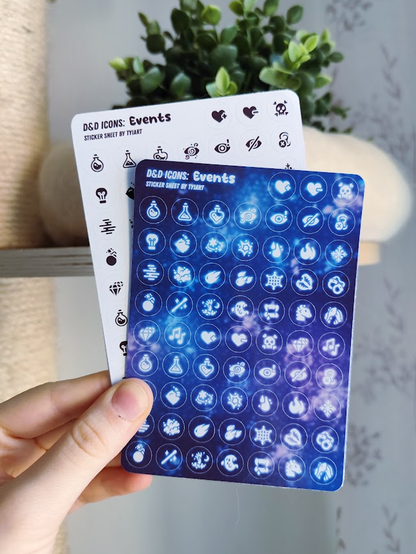 hand holding up a white sticker sheet with tiny black icons and a shiny space themed one, both showing different DnD quests and events