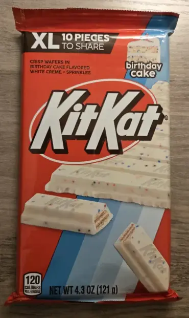 A large KitKat candy bar with with white cream and sprinkles. The wrapper reads "XL 10 Pieces to Share". 

No. It's all mine.