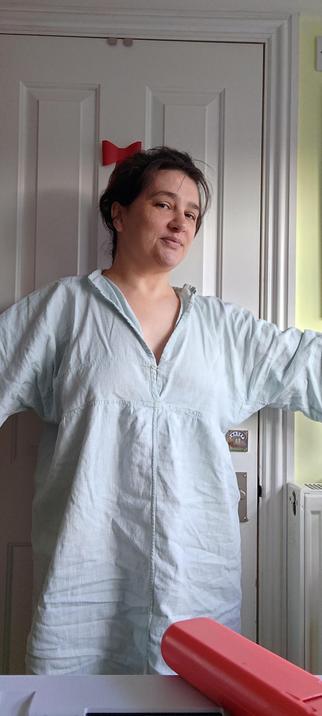 Me in a sacklike very pale green garment with an open collar