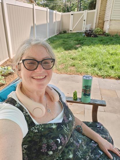 I am wearing a strappy dress, print is flowers, Luna moths, crescent moons on black, over a white tee