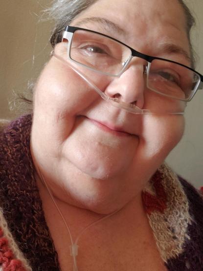 Me, an anglo woman, hair pulled back, glasses, canula on face