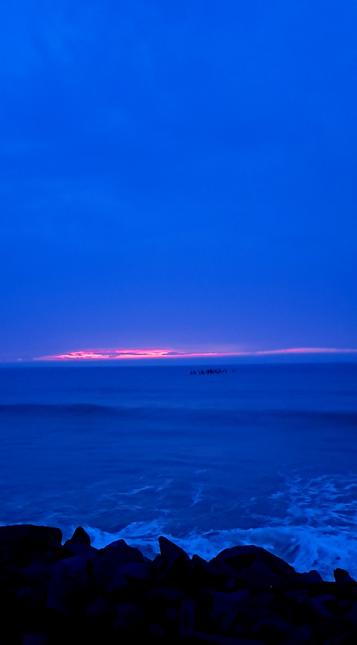 Morning sun rising over the clouds. More like split sun. Sky and ocean are the same color of regal blue. May we all have such blues in our days that makes our days worthwhile.