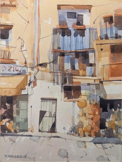 Watercolor painting of ground floor shops and upper story apartments along Piazza Guglielmo II in Monreale, Sicily. Balcony terraces are recessed and in purple-blue shadows above overhangs and canopies to ground floor store fronts. The store to the left has a canary colored awning hanging over blue-green storefront window displays and an interior on shades purples, reds and oranges. The store to the right has a white awning hanging over a dark store interior and orange wares hanging from a board leaned against the building. Separating the two stores is a gated and papered empty entry way. The sun casts long rectangular shadows within the balcony grates.