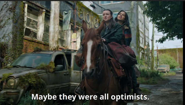2 protagonistes (de la série The Last of Us S02e4) passent à cheval devant l'immeuble - un camion défoncé est stationné devant - le dialogue dit "peut-être qu'ils étaient tous optimistes" en référence au drapeau lgbt arce en ciel de l'image précédente