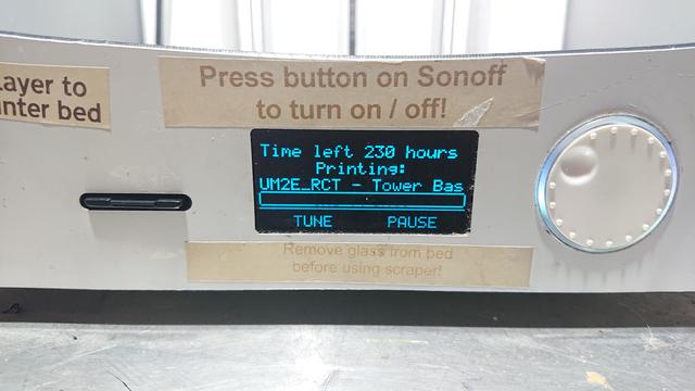 Close up of the controls on an Ultimaker 3D printer showing the progress screen: an empty progress bar under the text "Time left: 230 hours"