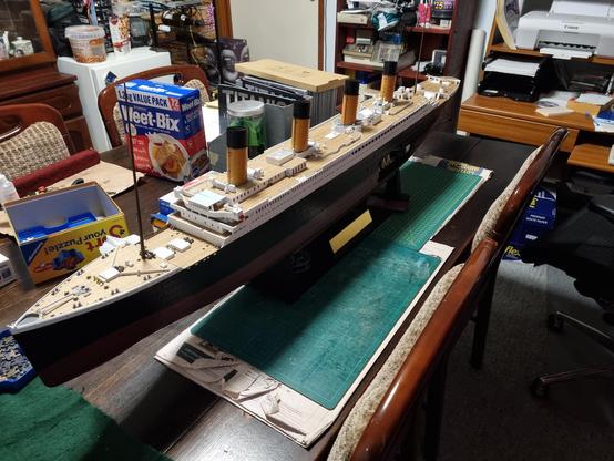 Model Titanic resting on its stand.