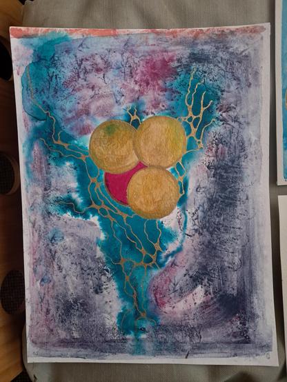 An abstract work of art. Four spheres, three golden but not uniform gold, streaked gold, and a hint of blue turquoise colour. One red sphere behind the golden ones, almost peeking out from behind the other three. It has a darker red / blacker edge but not linear, more thick and thin. The red sphere has a golden line around its edge. There is a kind of Y shaped bluey turquoise background behind the sphere's. The Y shape moves more upward to the left than to the right. The blue Y shape has golden (hard to describe) lightening? Nerve connections? Around the edges is.. My best description is a charcoaly but it isn't charcoal, and I am aware that's a crappy descripton, muddy, but not brown, more black, pinky purple. 

I will add alt txt to the others tomorrow. 

I'm going to say how I feel about it. I know I'm supposed to stick to descriptive, but bugger it. I think this is descriptive too. Let me know if it's not helpful.

When I first saw it I REALLY wanted it. It sounds daft but it spoke to me. It says life and struggle and hope and a healthy helping of chaos and angry. I fucking love it and I can't fully explain why. It's just lovely.