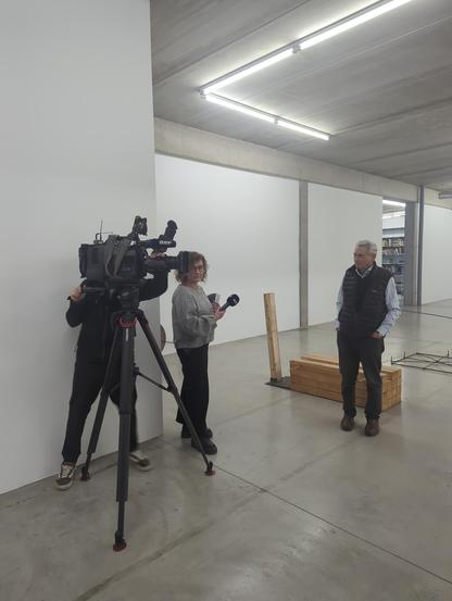 A TV Camera, a Journalist and the artist  Wolfgang Nestler while doing an Interview