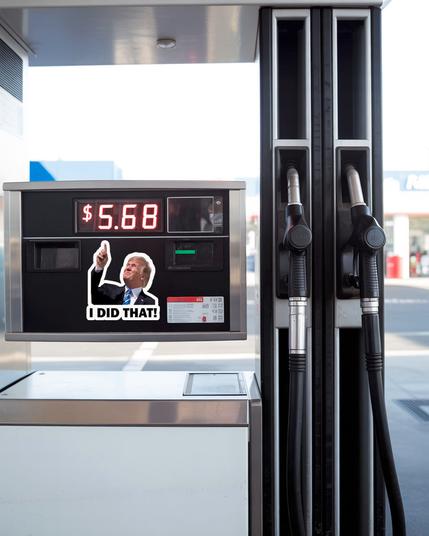 Picture of current president pointing to 5.68 dollar gas price on a pump