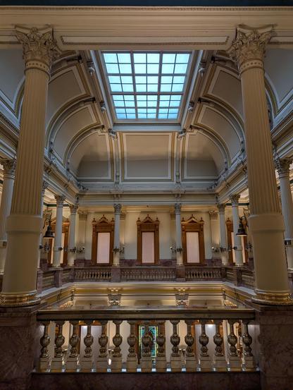 Inside the Colorado Capitol Building. Large open area with ornate pillars and decorations.