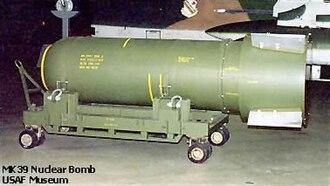 Mark 39 Mod 2 nuclear bomb, green, with yellow writing on it, on a cart. By http://www.wpafb.af.mil/museum/arm/sw.htm, Public Domain, https://commons.wikimedia.org/w/index.php?curid=415521