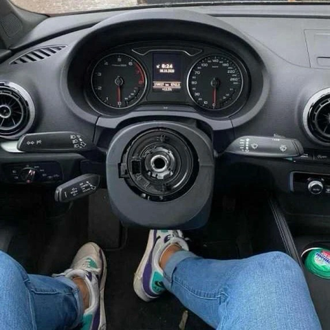 Driver’s perspective of a dashboard missing the steering wheel.