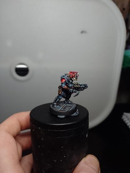 Miniature of a humanoid rat clutching a big gun