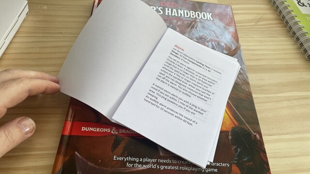 Inside first page of Spellbook. Book signatures folded ready for stitching on top of D&D Players Handbook