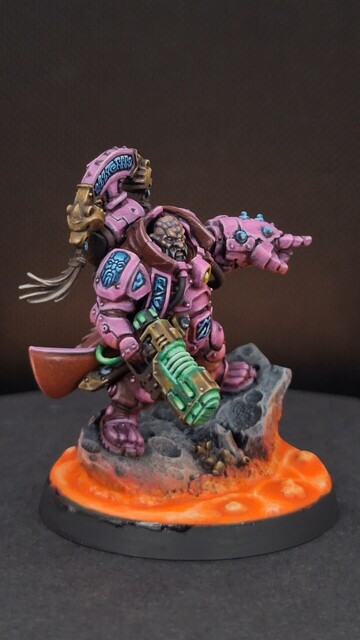 Finished space dwarf miniature in bright pink armour with glowing magma on the base