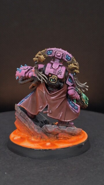 Finished space dwarf miniature in bright pink armour with glowing magma on the base