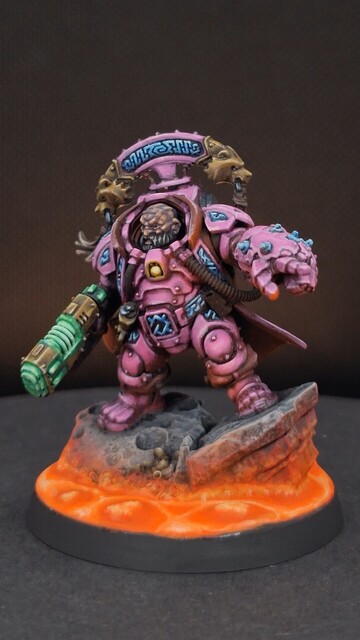 Finished space dwarf miniature in bright pink armour with glowing magma on the base