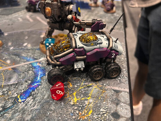 A Votann Sagittaur, painted in white and purple. The canopy windows have been tinted yellow, which helps it stick out even more from similar forces.