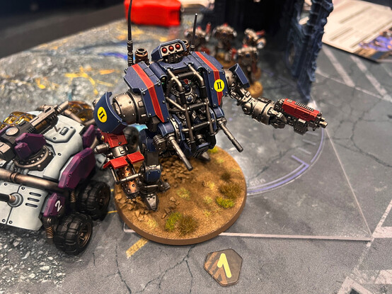 An Invictor Tactical Warsuit from Warhammer 40k. The Warsuit was blue with red stripes and silver mechanical workings. I was absolutely in love with the crisp paintjob here, even down to the individually painted rivets.