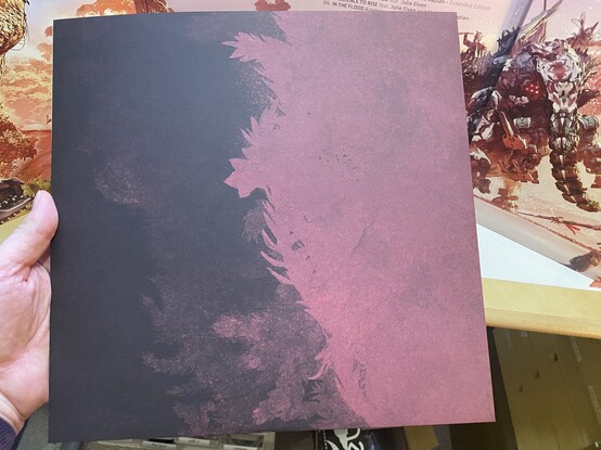 Illustrated dust cover for the first disc, with abstract magenta feathery art. 