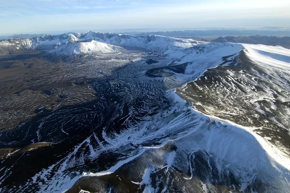 aerial photo: Part of Aniakchak’s caldera rim. Pre-caldera volcanic rocks are exposed in Aniakchak’s caldera walls.