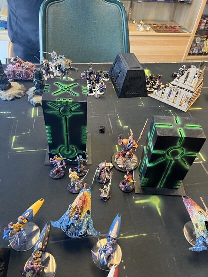 Warhammer 40K Battle

Eldar Solitaire engaged in combat with a big squad of sisters. I didn’t realize how many wounds the coffin escort “character” when I assigned his attacks to it. Did ten wounds and died in the counter attack. 

Avatar of Khaine between two Necron columns, bright colored wraithblades, harlequin star weavers and skyweavers behind them. 

Other side if battle some sisters squads, plus a small knight and a red flamer equipped transport. 
