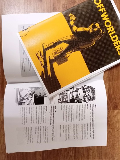 Photo of two printed Offworlders RPG booklets.