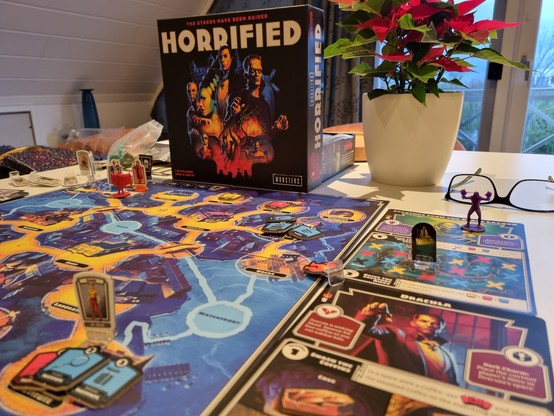 A view across the board of the game Horrified looking at the art on the box lid. 