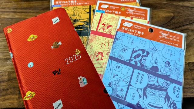 Hobonichi weeks planner with a red one piece themed cover and 3 different sizes of one piece pencil boards